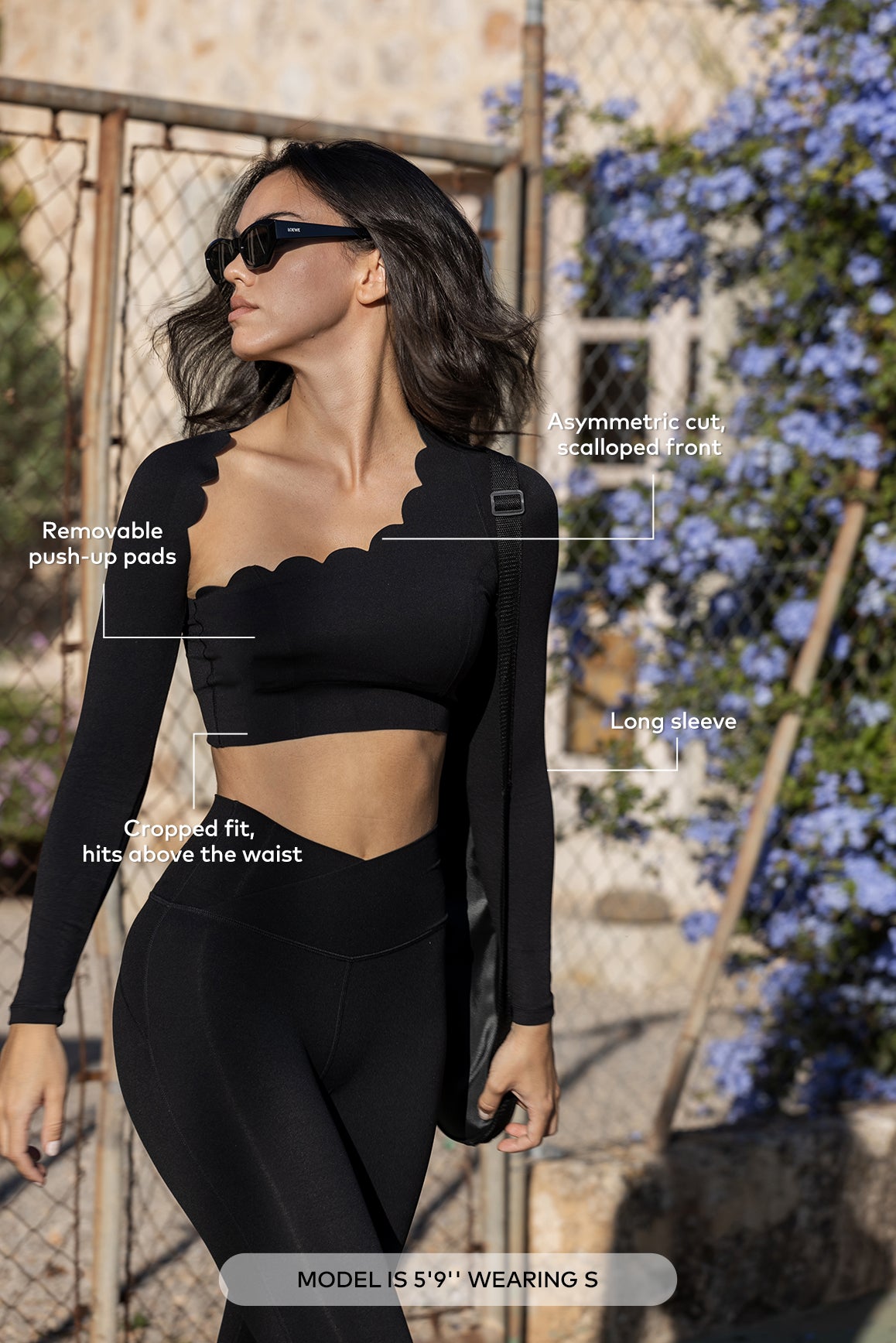 Asymmetrical long sleeve crop top in black by WISKII, featuring a stylish cut and soft fabric, perfect for casual wear.