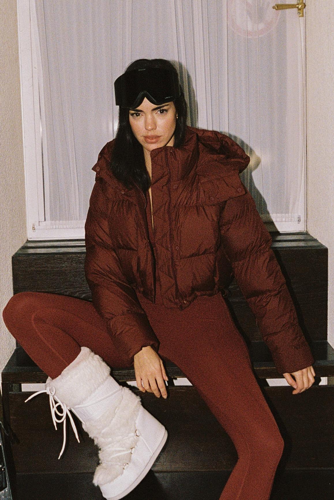 WISKII Cropped Convert Down Jacket, hooded, lightweight, with a sleek design, displayed on a hanger.