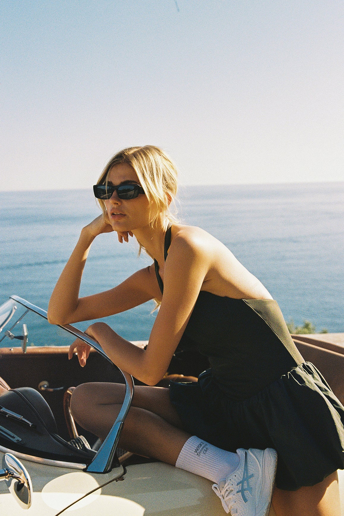 Model wears a Riviera Floral Backless Halter Dress | WISKII Active | Deepsea dress