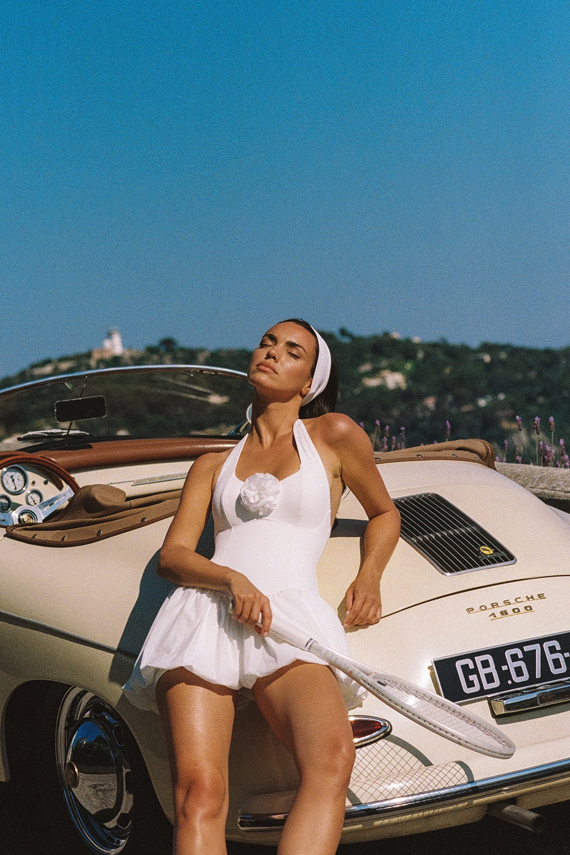 Model wears a Riviera Floral Backless Halter Dress | ivory | WISKII Active