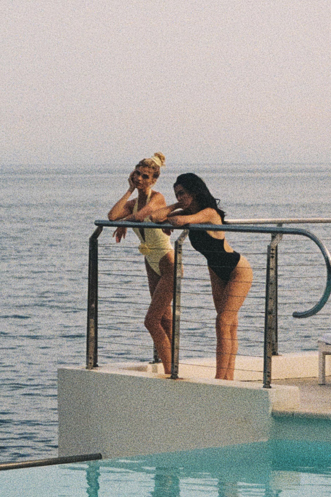 Model wears a Riviera Floral Backless One-piece Swimsuit | Black Swimsuit | WISKII Active