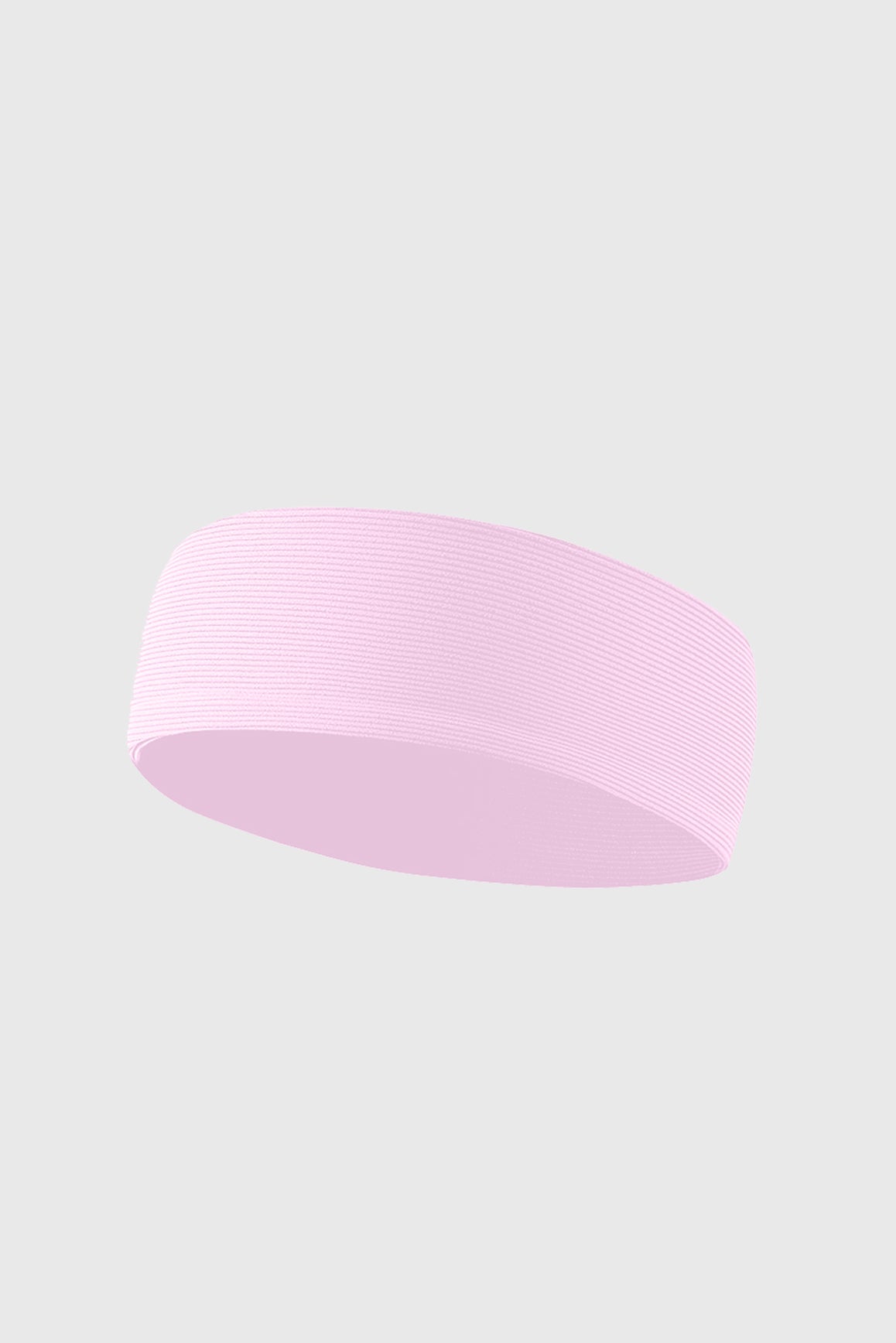 Pink stretchy ribbed headband from WISKII with a soft, textured fabric, styled as a comfortable accessory for active wear.
