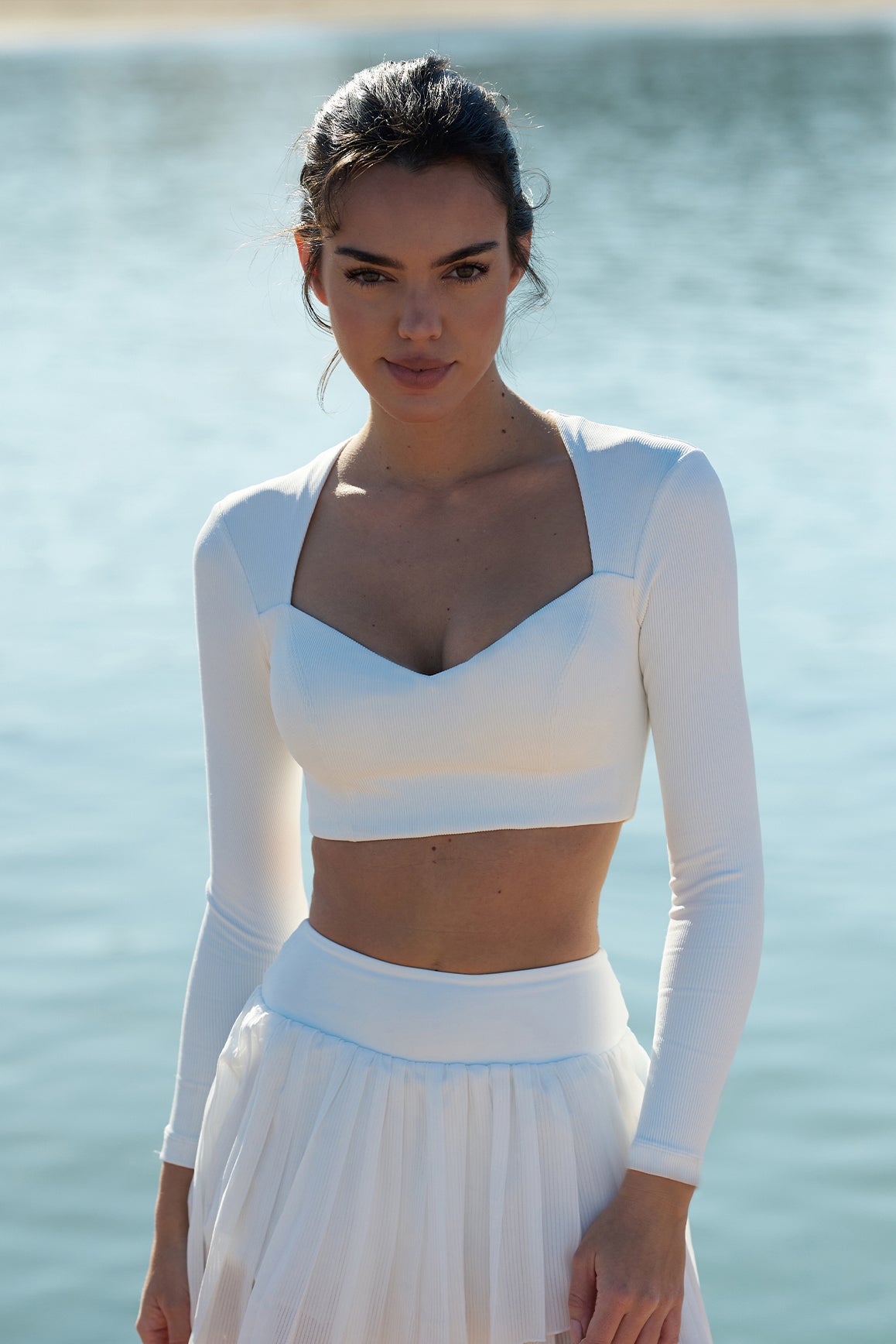 Model wears WISKII Elegant Long Sleeve Crop Top | Ivory