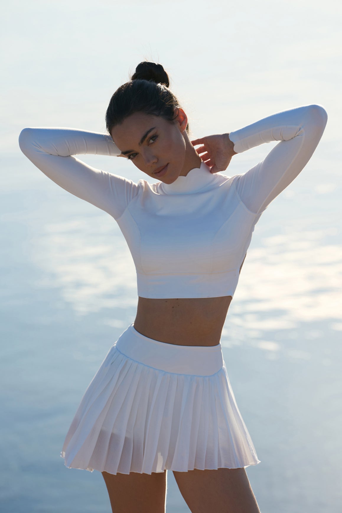 Model wears WISKII Lite Pleated Skirt