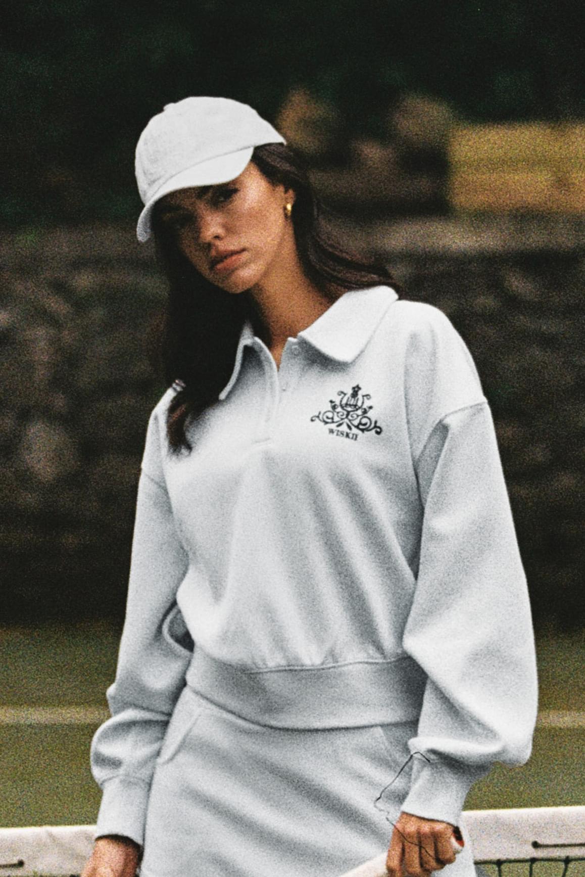 WISKII polo button front sweatshirt in loungewear style, featuring a classic collar and button placket, displayed on a neutral background.
