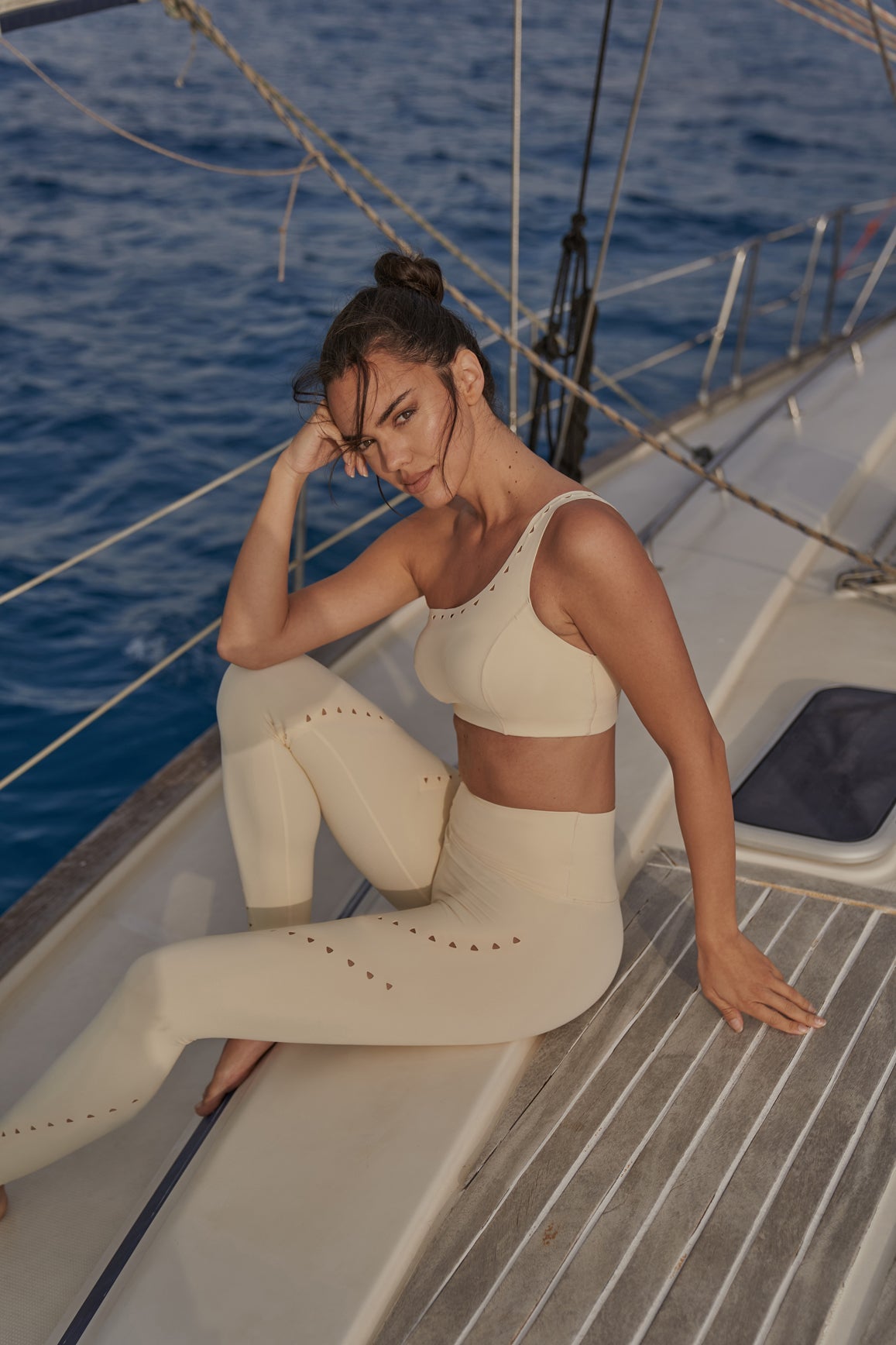 Model wears One-Shoulder Laser Cut Sports Bra + V-Waist Laser Cut Sports Legging | WISKII