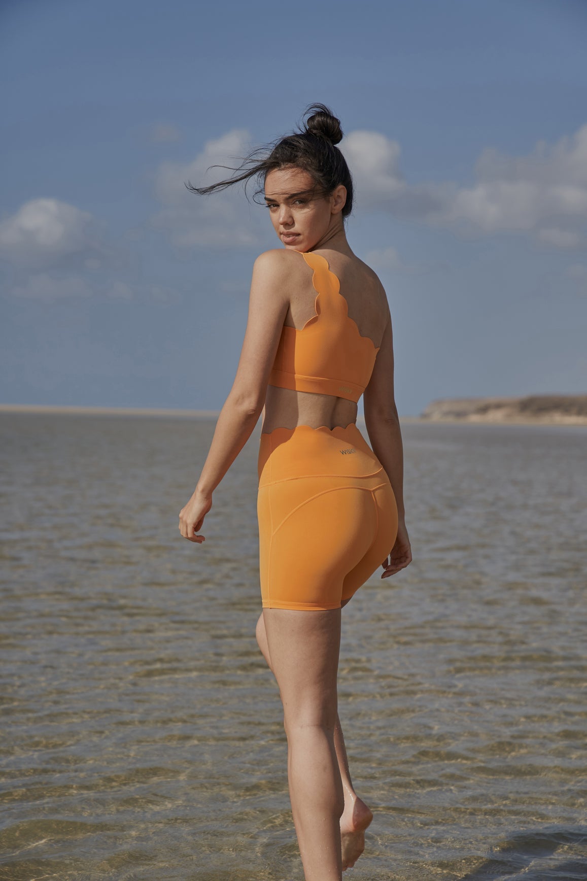 Model wears Dynamic One Shoulder Sports Bra + High-Waist Sculpting Biker Short|WISKII Active|Flameorange
