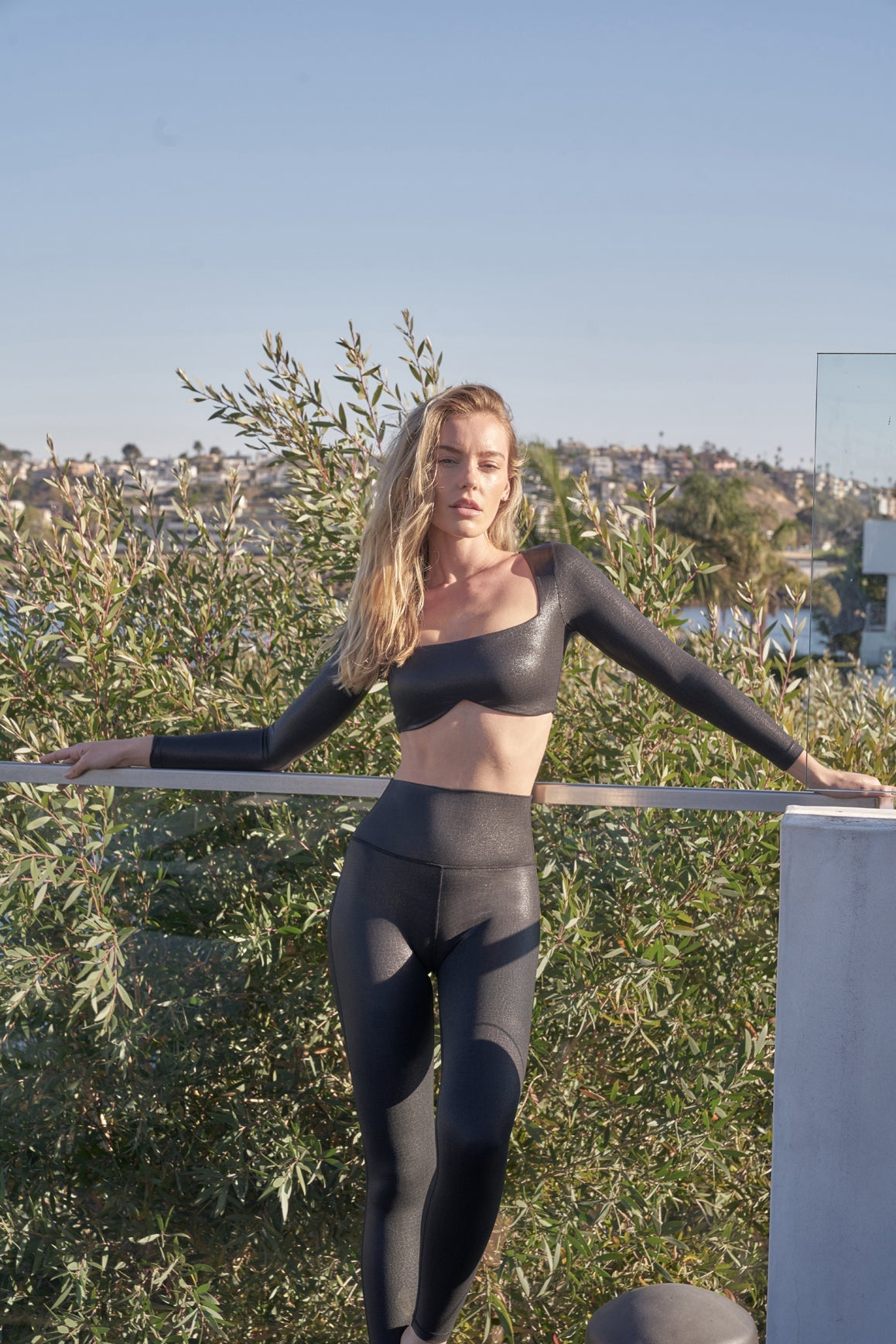 Black faux leather long sleeve crop top bra by WISKII, featuring a sleek design and fitted style for a modern look.