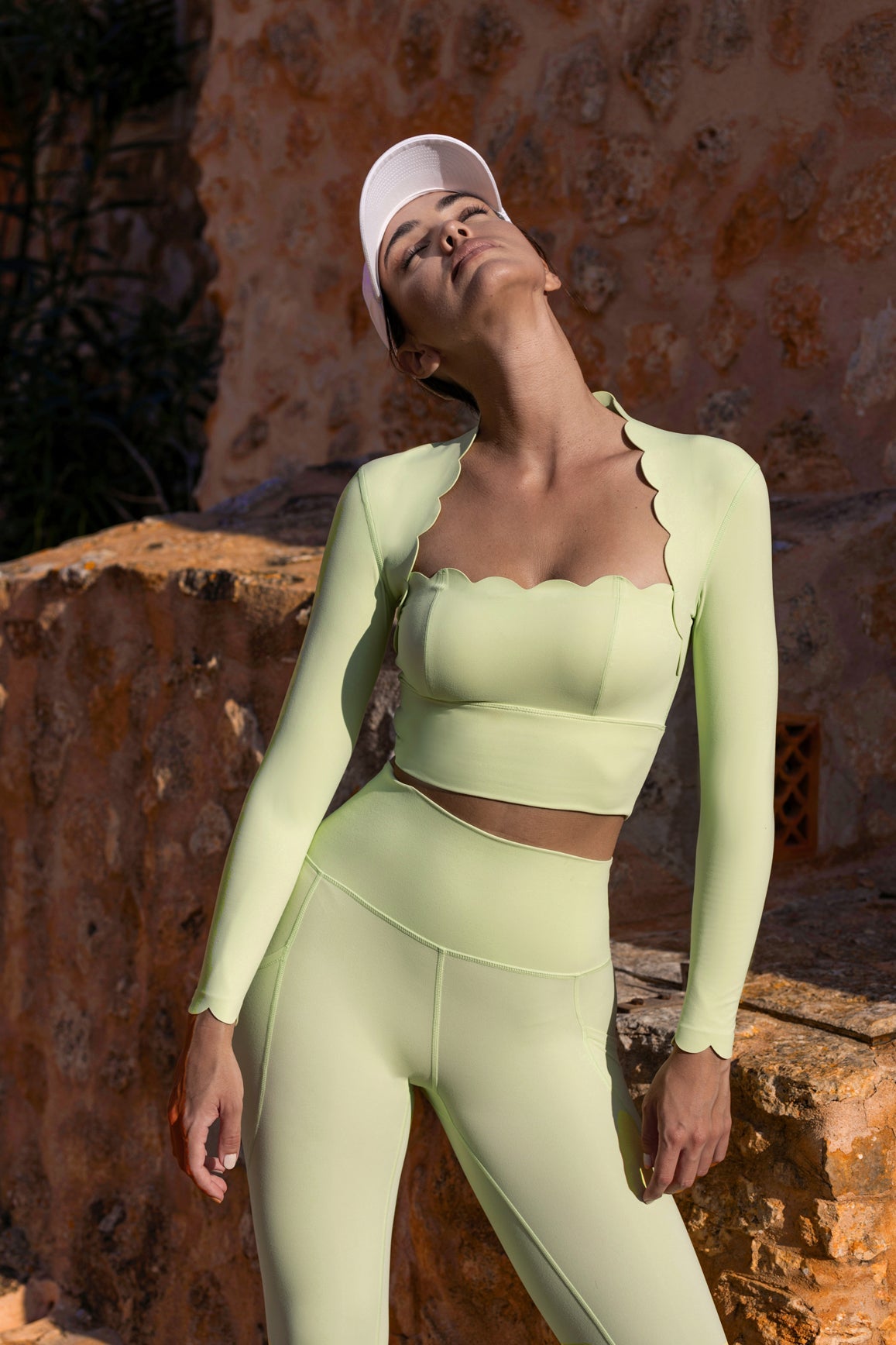 WISKII matcha green scallop cropped long sleeve top with a relaxed fit and delicate scalloped edges.