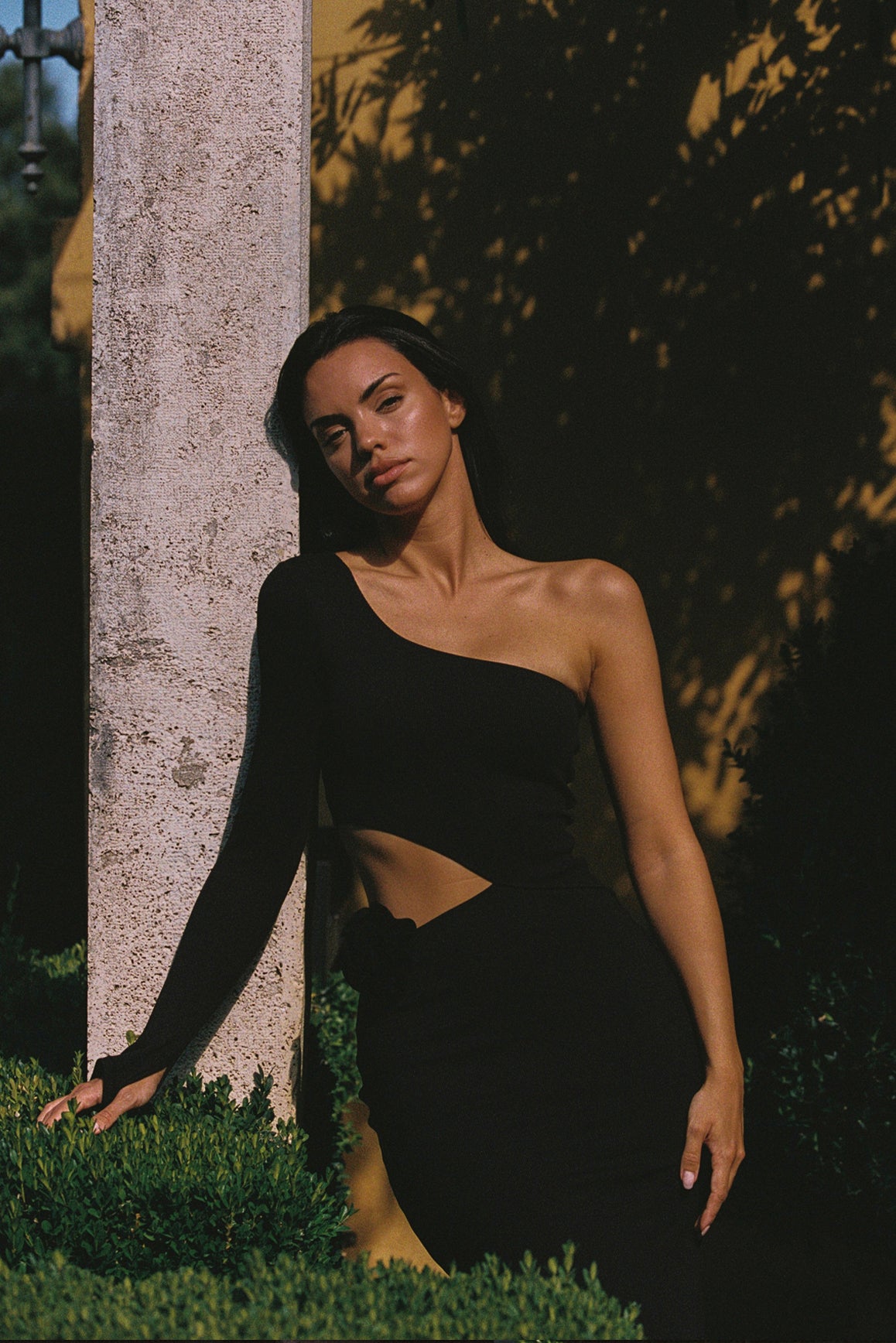 Black WISKII asymmetrical floral maxi dress featuring a flowing design and vibrant floral patterns.