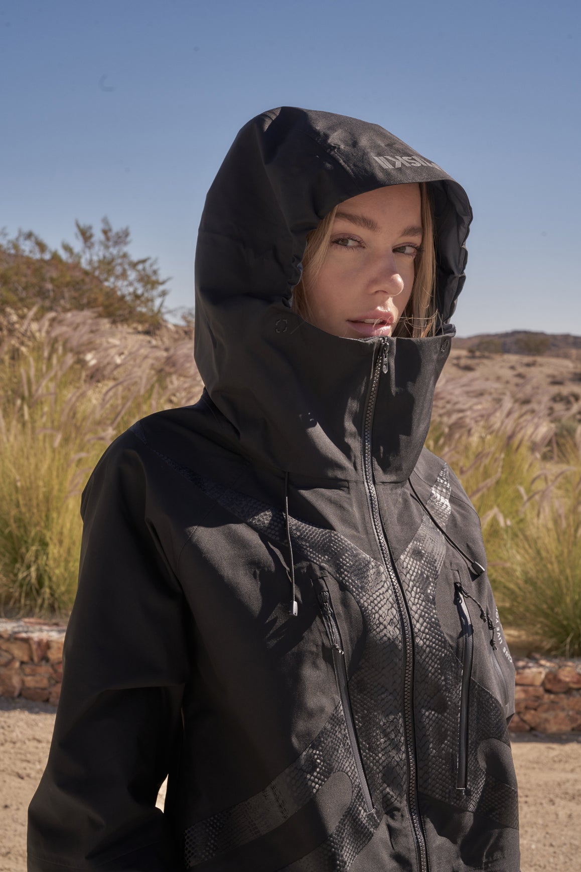 Black WISKII 3L waterproof hardshell performance jacket with hood, designed for outdoor protection and activewear.
