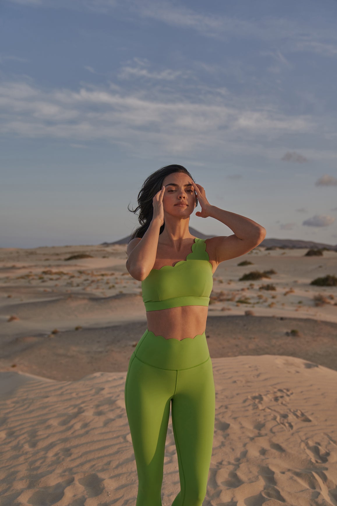 Green WISKII 7/8 high-waist energy leggings shown on a model, featuring a snug fit and stretchy fabric for active wear.