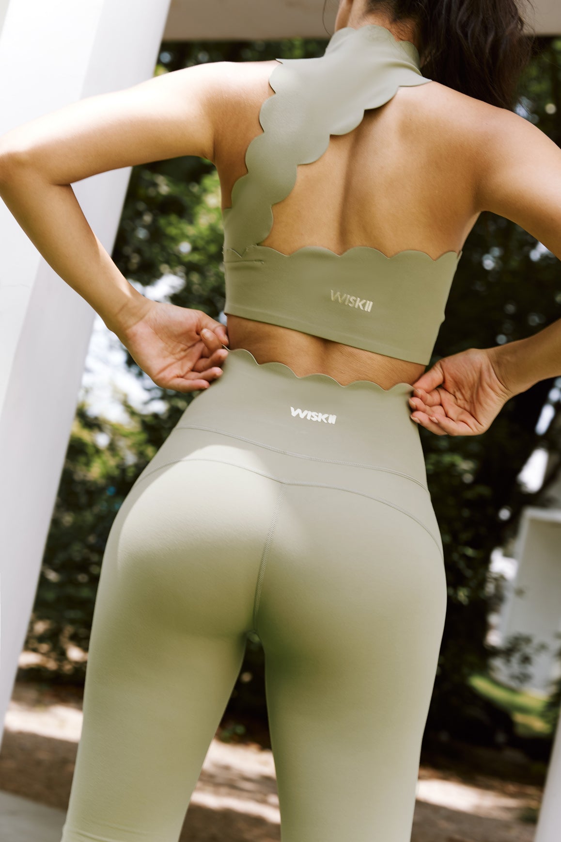 Ivory high-waist flare leggings by WISKII, showing the fit and style on a model with a focus on the leg design and fabric texture.