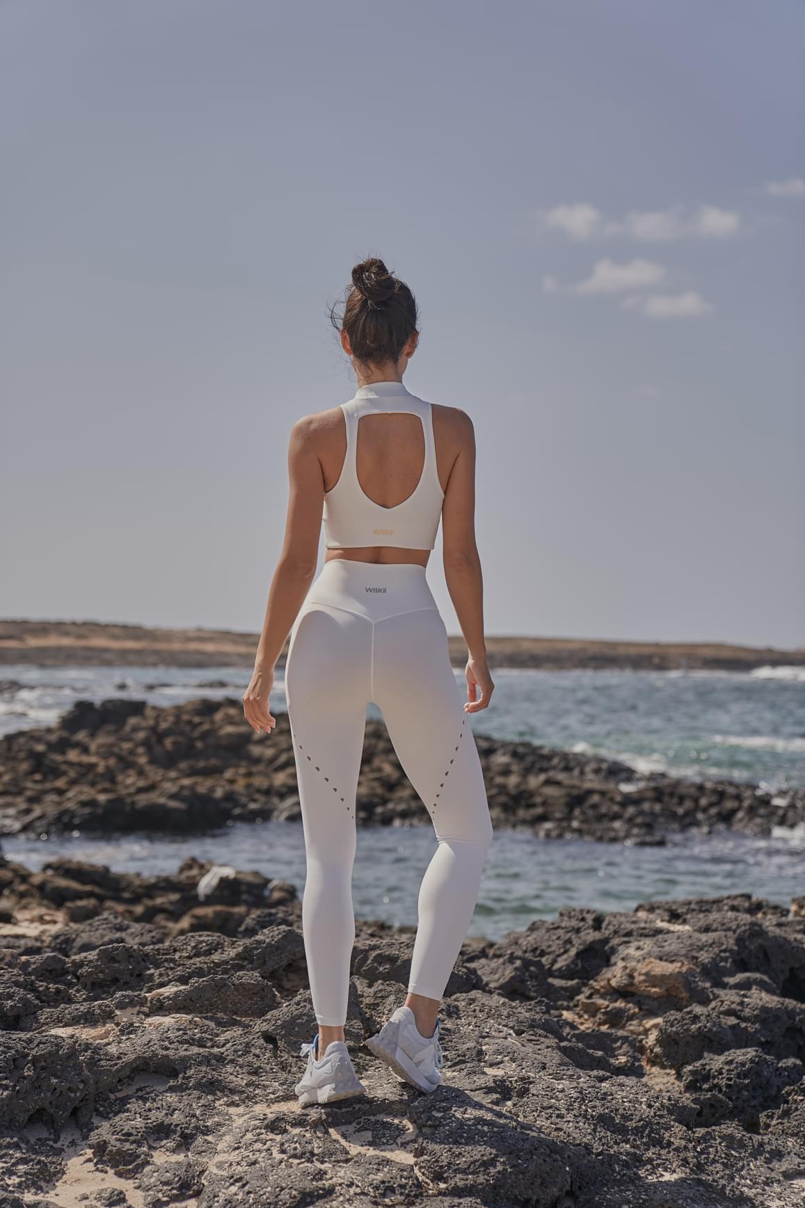 Ivory WISKII training laser cut leggings showing intricate laser cut details and a snug, stretchy fit for active wear.