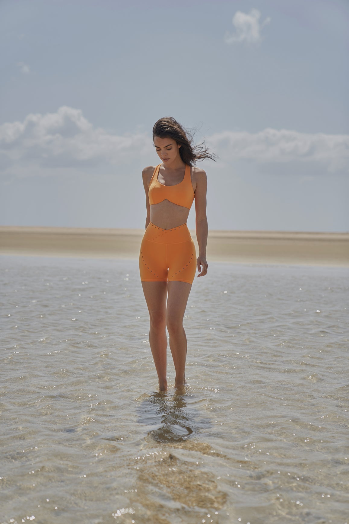 WISKII flame orange V-waist laser cut sports shorts, lightweight athletic shorts with stylish cut-out design for active wear