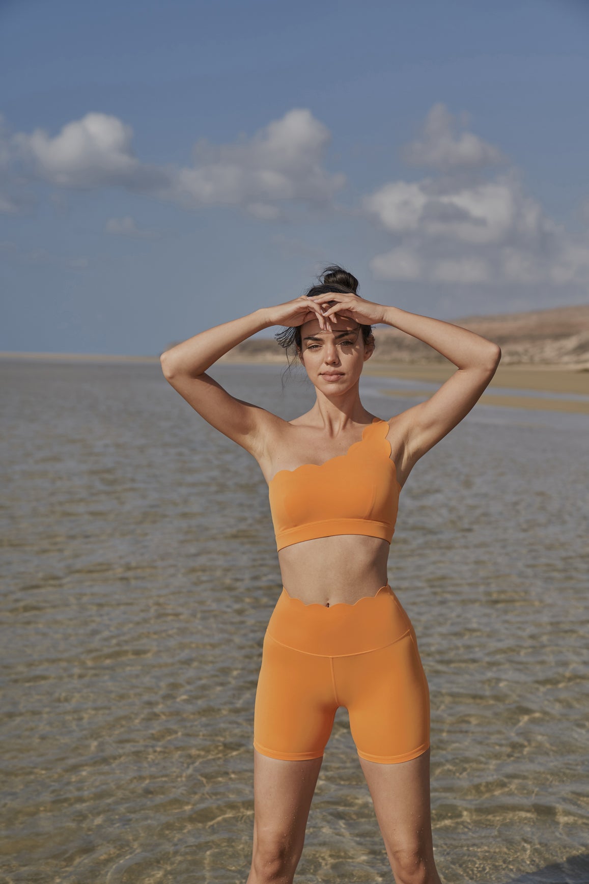 Ivory high-waist sculpting biker shorts by WISKII, designed to shape and flatter with a snug fit.