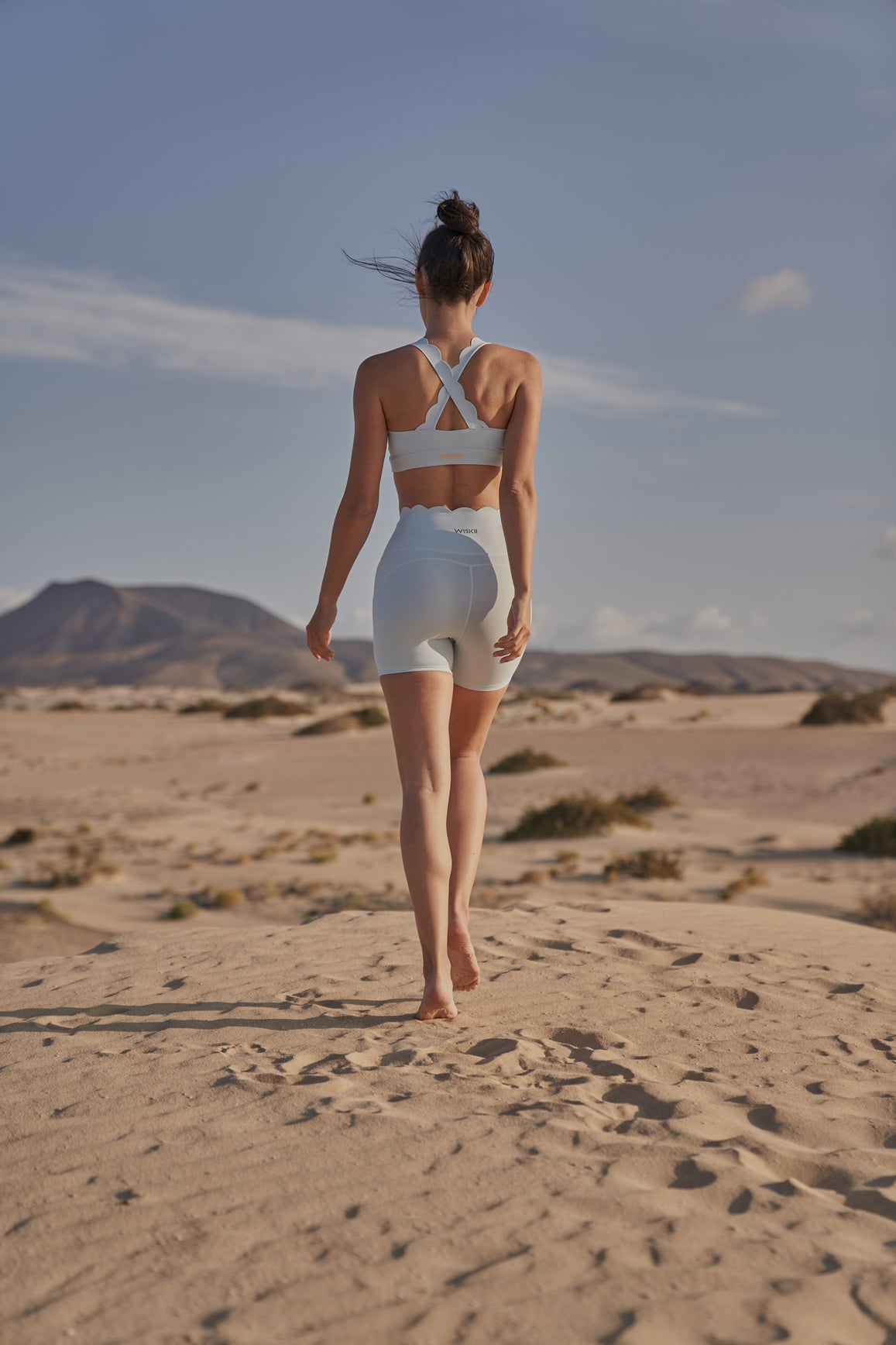 Ivory high-waist sculpting biker shorts by WISKII, close-up view showing smooth, stretchy fabric and snug fit for active wear.