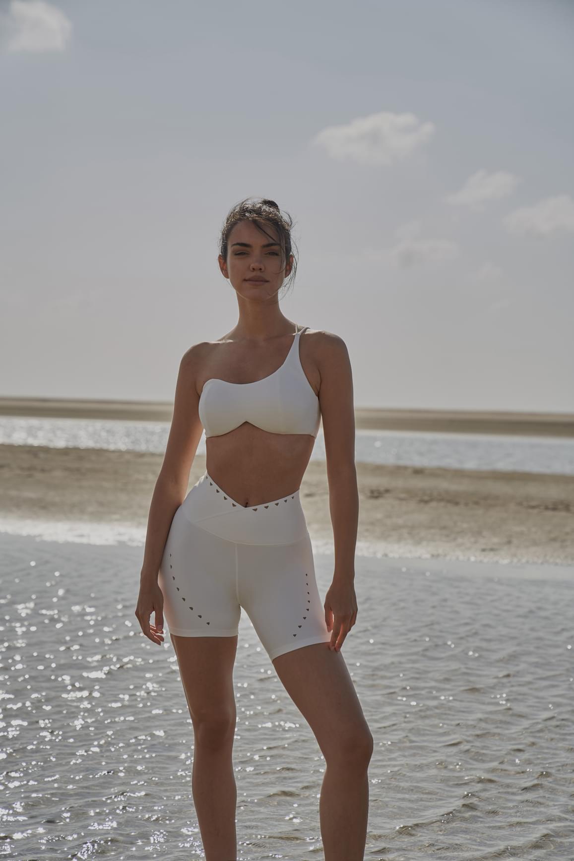 Pink WISKII V-waist laser cut sports shorts with stylish cut-out details, designed for active wear and comfort.
