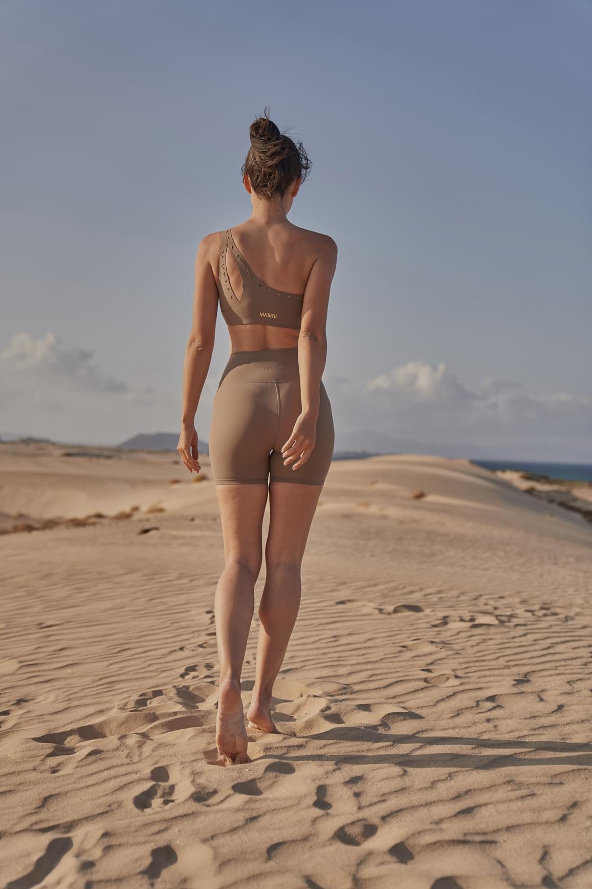 Pink WISKII V-waist laser cut sports shorts with stylish cutout details, perfect for activewear and casual outfits.