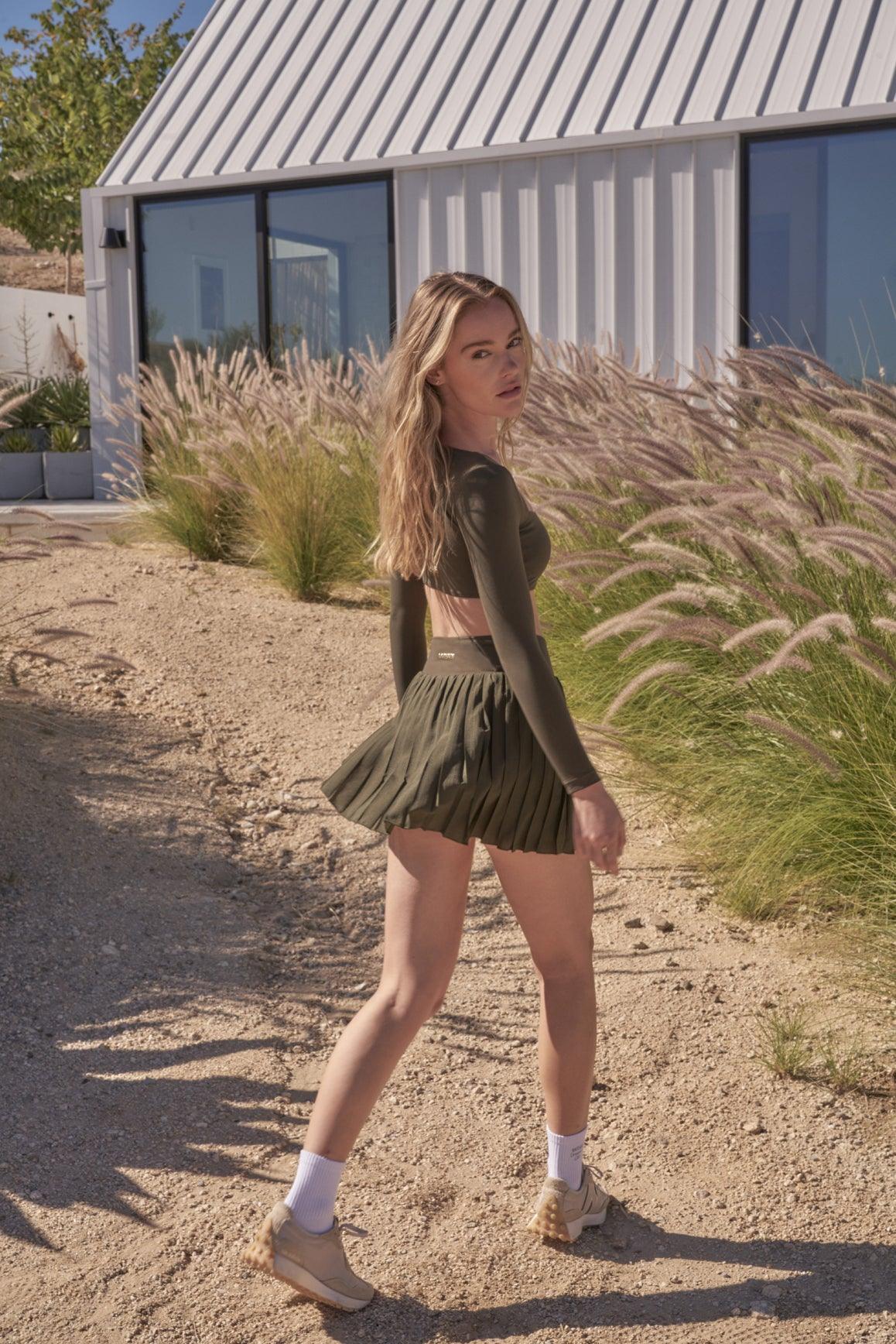 Ivory WISKII Lite Pleated Skirt, flowing fabric with pleats, styled for casual or dressy occasions.