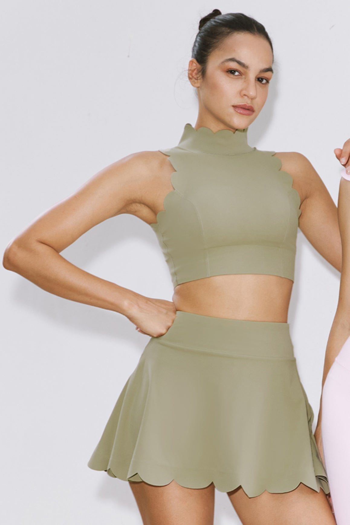 Muted khaki WISKII high-waist A-line tennis skirt, showcasing a sleek, sporty design with a comfortable fit and stylish silhouette.