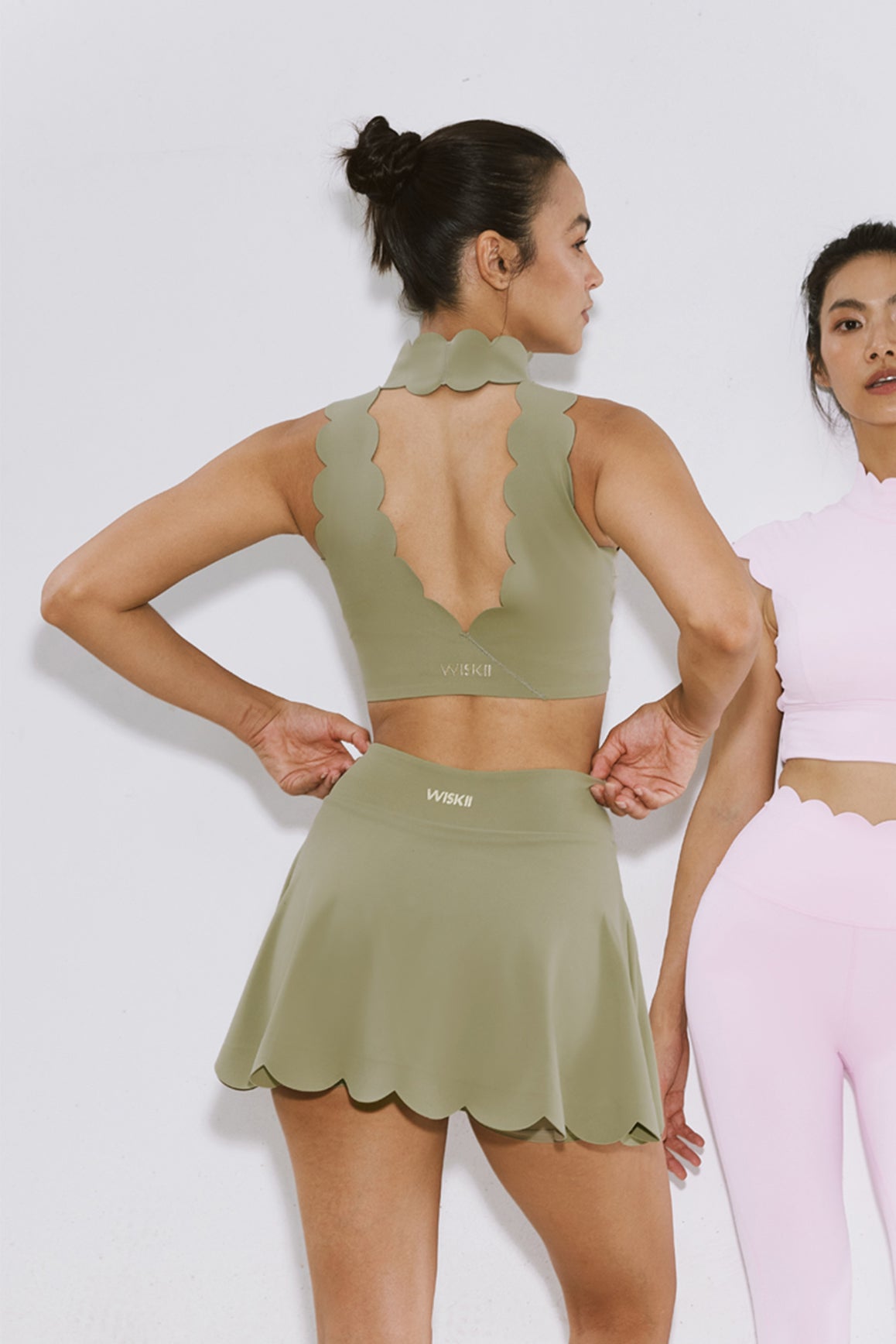 WISKII high-waist khaki A-line tennis skirt with pleats and functional side pockets, designed for active sportswear.