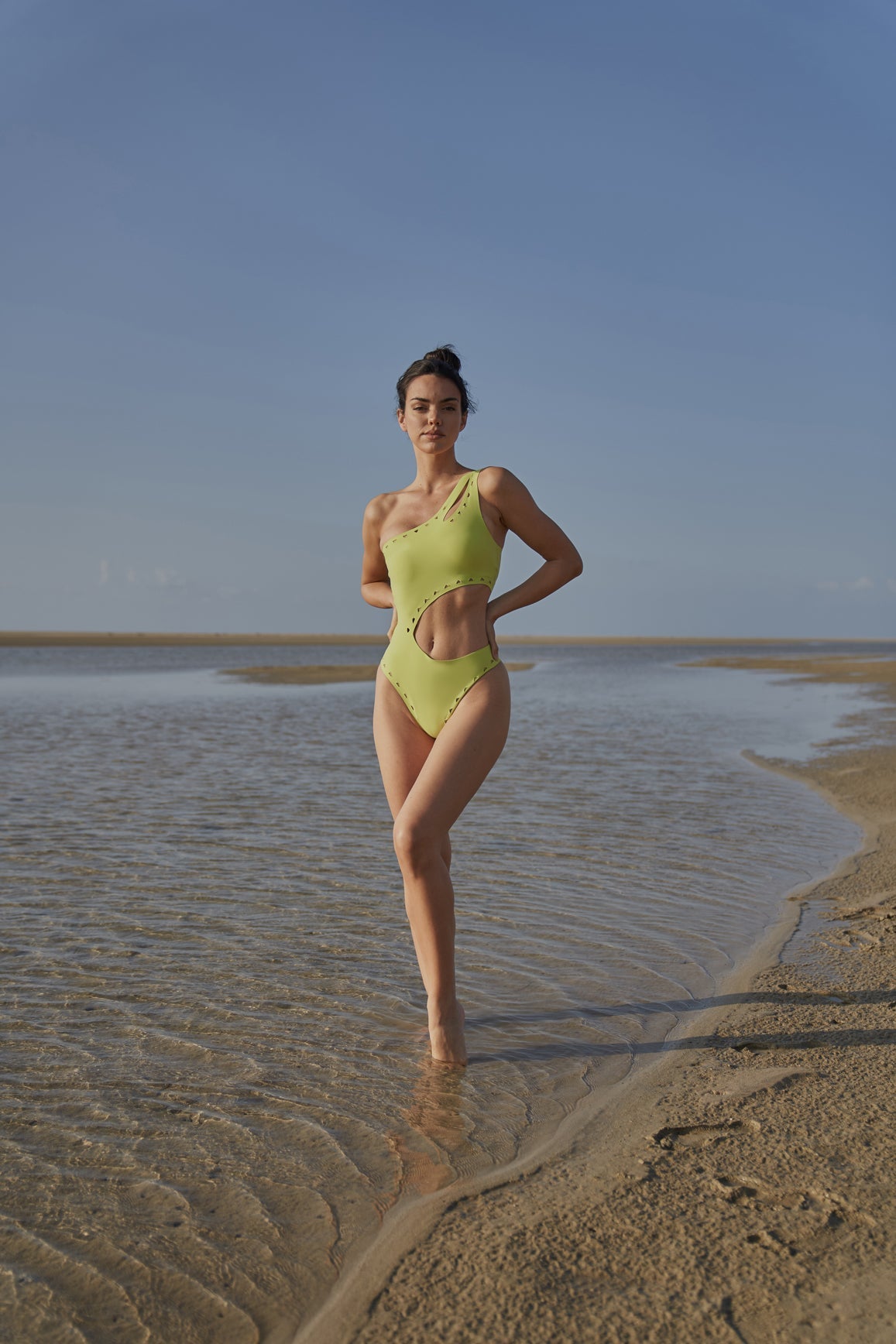 WISKII one shoulder laser cut swimsuit in bitter lime color, featuring a stylish asymmetrical design and cut-out details.