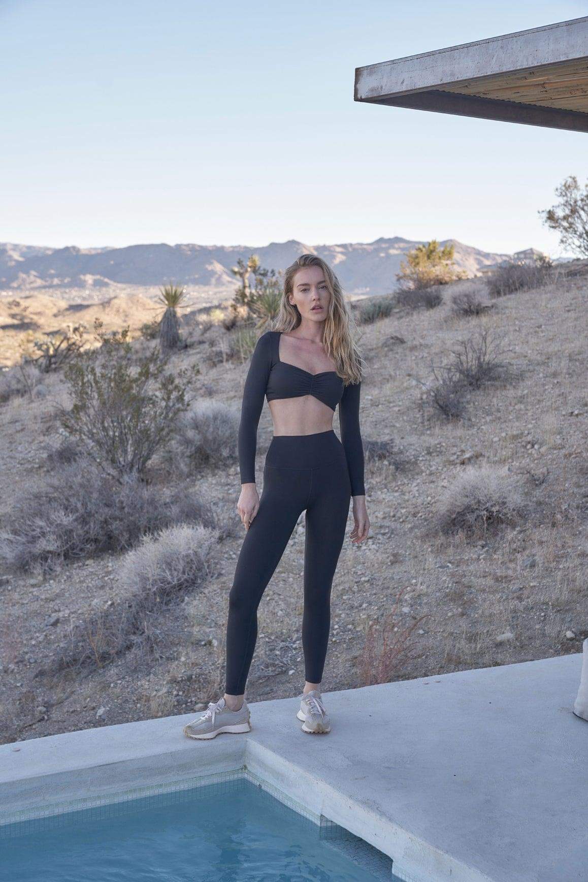 Ivory long sleeve cropped top with ruched design by WISKII, featuring a fitted style and soft fabric.