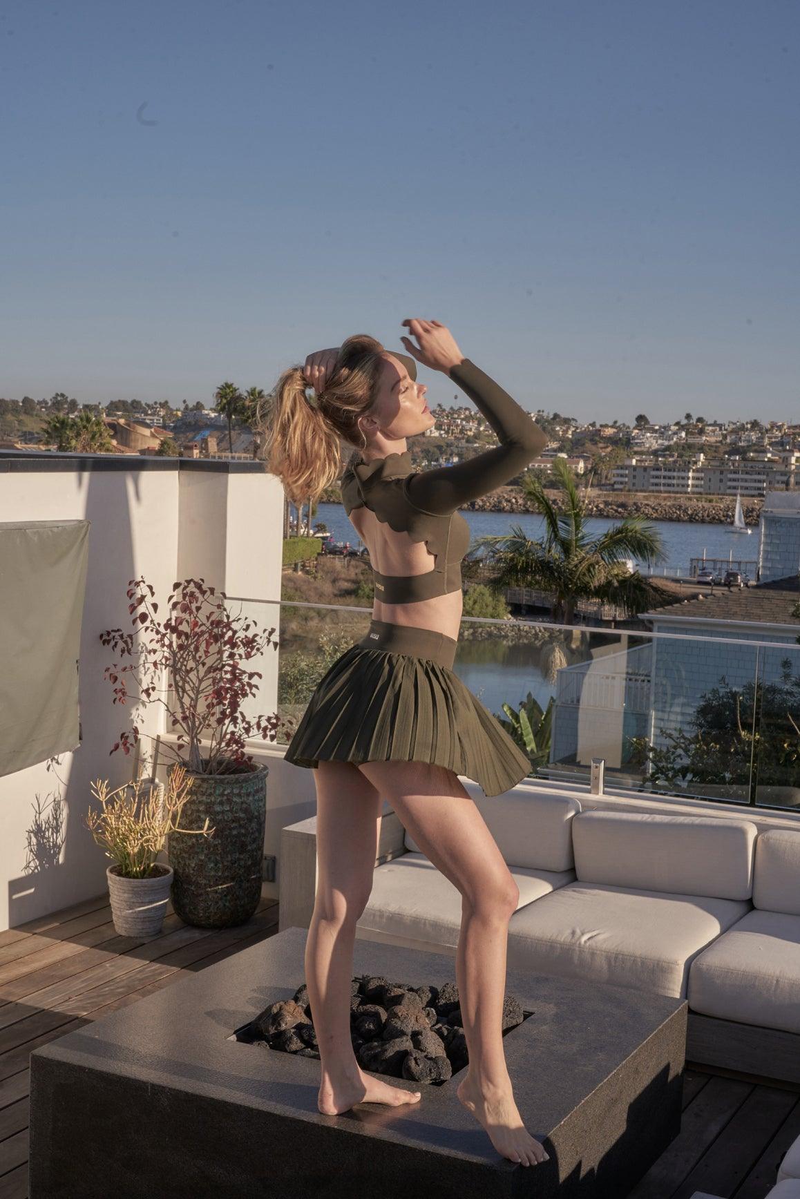Ivory open back long sleeve crop top by WISKII, stylish and fitted for casual or trendy outfits.