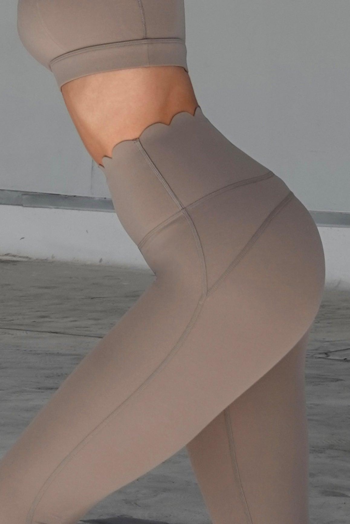 Ivory 7/8 high-waist energy leggings by WISKII, shown on a model, featuring a snug fit and high-rise waistband for active wear.