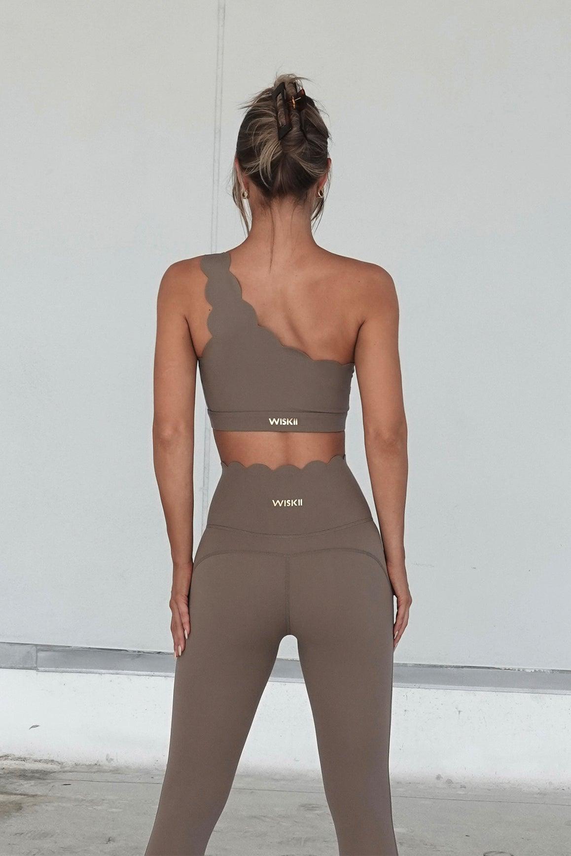 WISKII ivory 7/8 high-waist energy leggings shown on a model, close-up view of the snug fit and stretchy fabric
