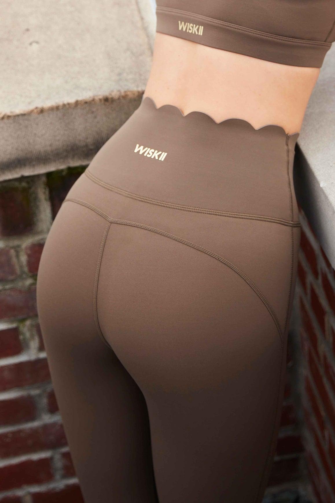 Ivory 7/8 high-waist energy leggings by WISKII, close-up of stretchy, high-rise waistband and smooth fabric fit.