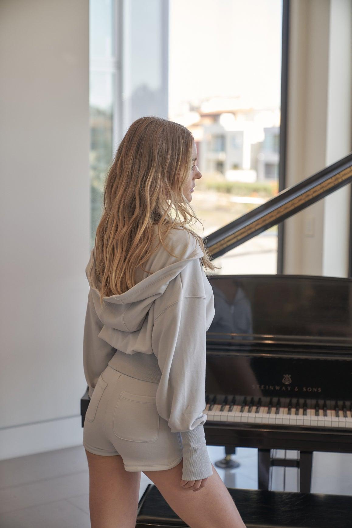 Cream WISKII Leisure Mini Shorts laid flat, showcasing lightweight fabric and stylish, casual design perfect for comfortable wear.