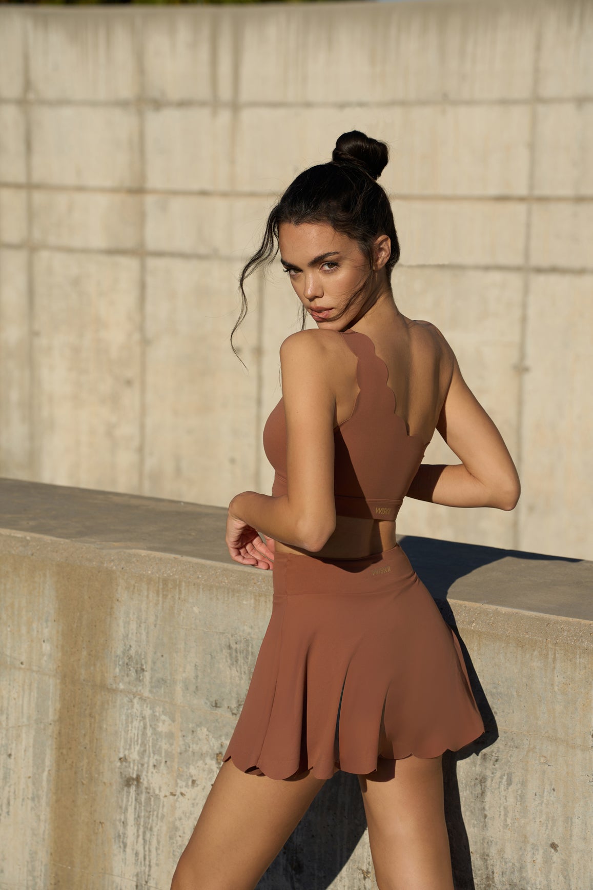 WISKII dynamic one-shoulder sports bra in cinnamon color, featuring a stylish and supportive design for active wear.