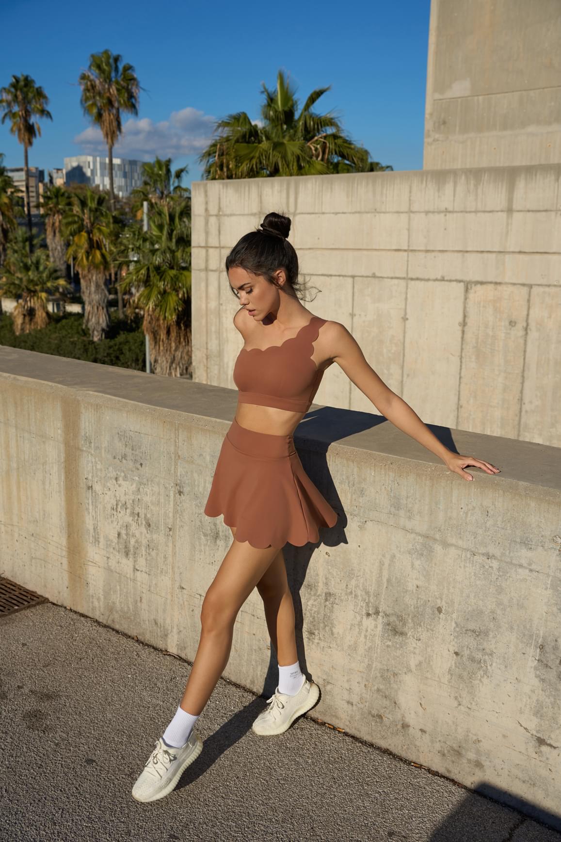 WISKII dynamic one shoulder sports bra in mulled wine color, showcasing its stylish design and comfortable fit for active wear.