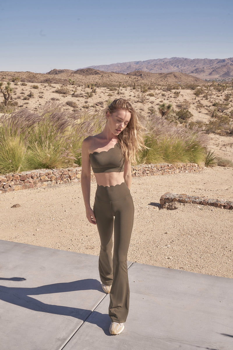 model wears Olive Green High-Waist Flare Legging pare with sports bra
