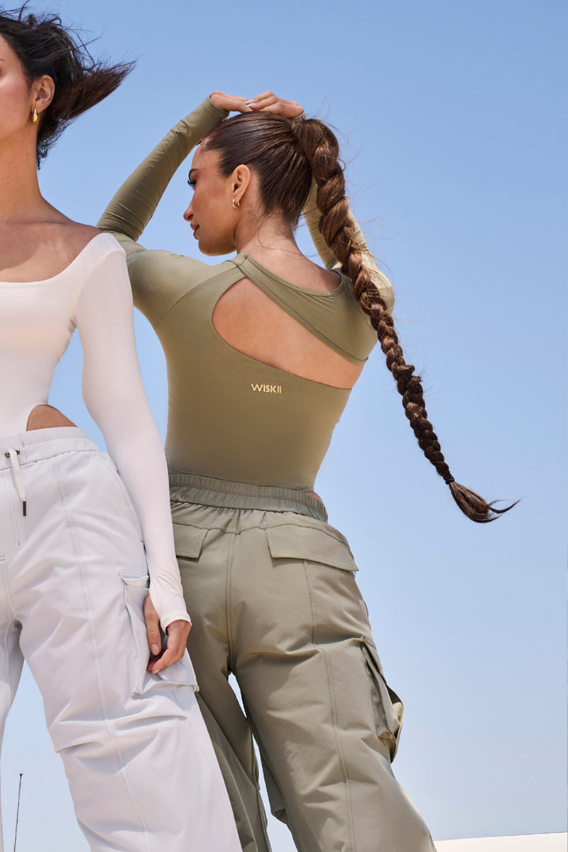 Model wears Unique Cut Long Sleeve Bodysuit | WISKII Active | Muted Khaki