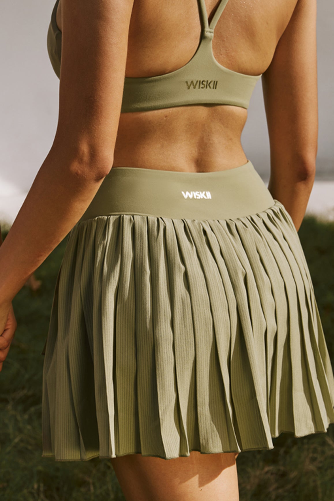 Model wears WISKII Pleated Skirts | WISKII ACTIVE