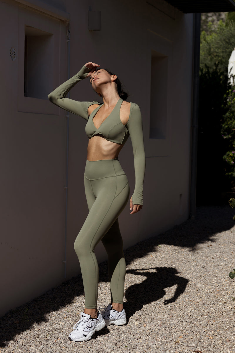 Model wears Twist-Front Shoulder Cut Crop Top | WISKII ACTIVE