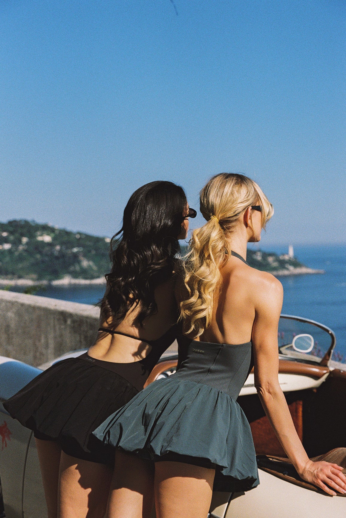 Model wears a Riviera Floral Backless Halter Dress | WISKII Active | Deepsea dress