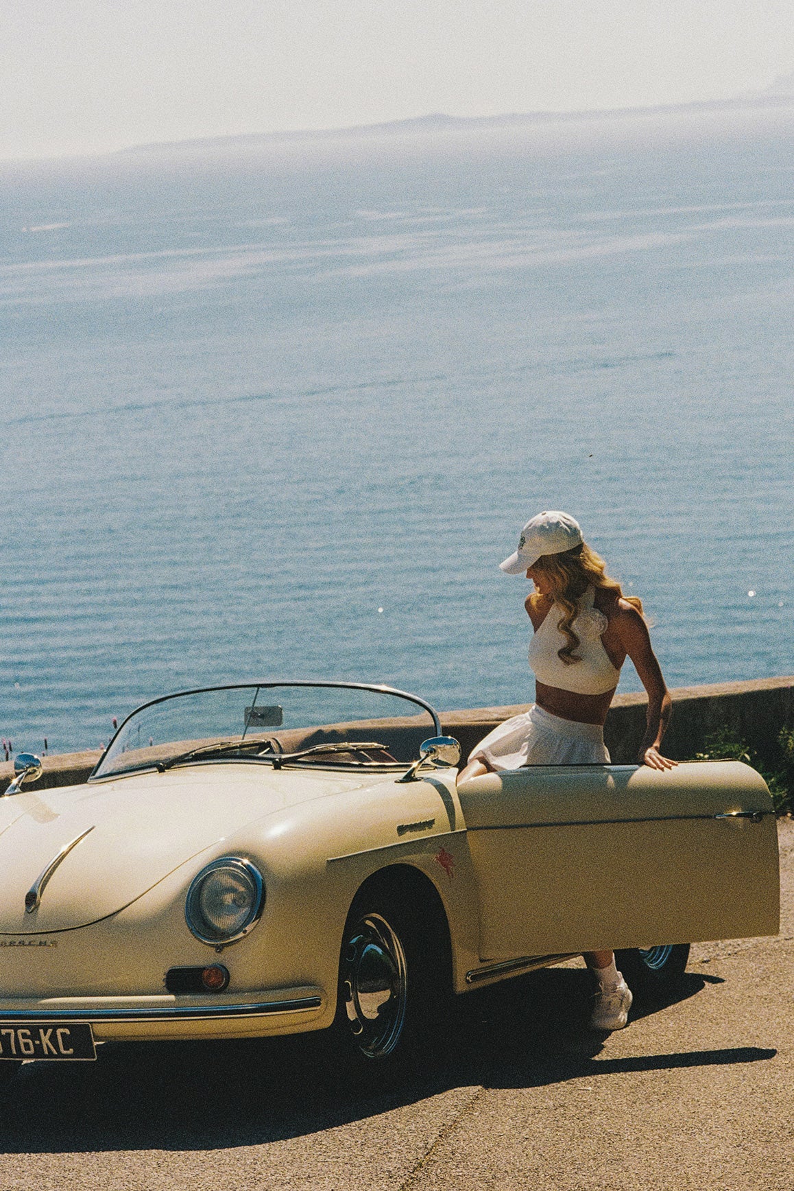 Model wears Riviera Floral Halter Mock Neck Top and Mini Bubble Skirt | Ivory | WISKII Active