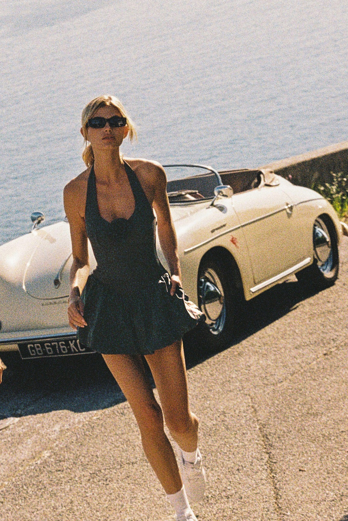 Model wears a Riviera Floral Backless Halter Dress | WISKII Active | Deepsea