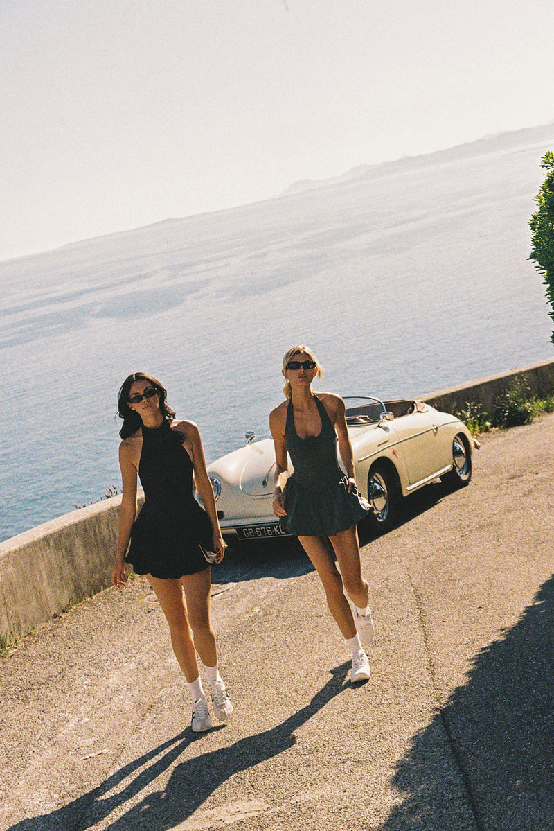 Model wears a Riviera Floral Halter Mock Neck Dress | Black | WISKII Active