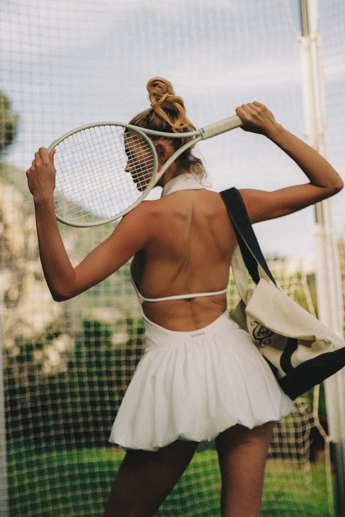 Model wears a Riviera Floral Halter Mock Neck Dress | Ivory | WISKII Active