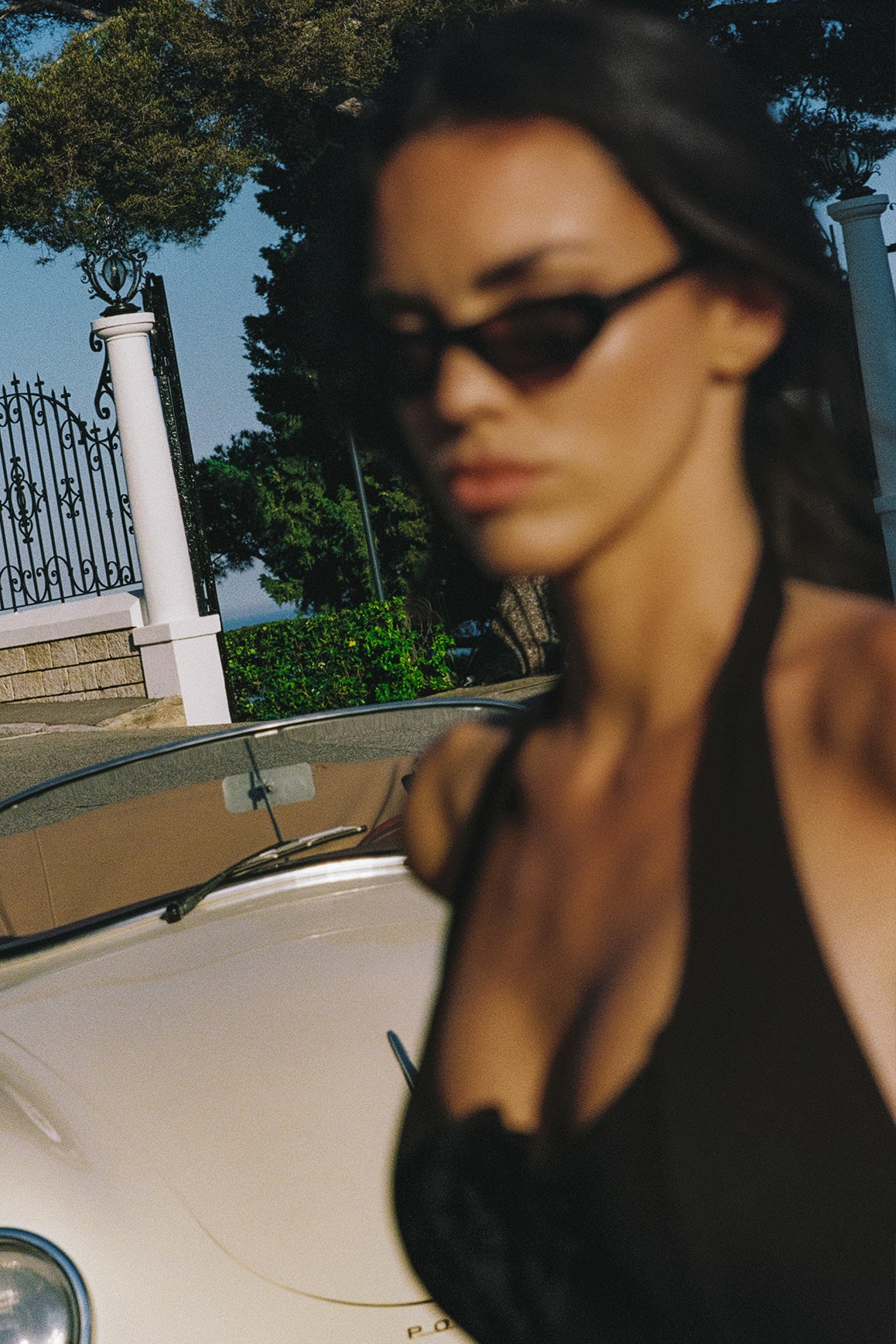 Model wears a Riviera Floral Backless Halter Dress | Black Floral | WISKII Active