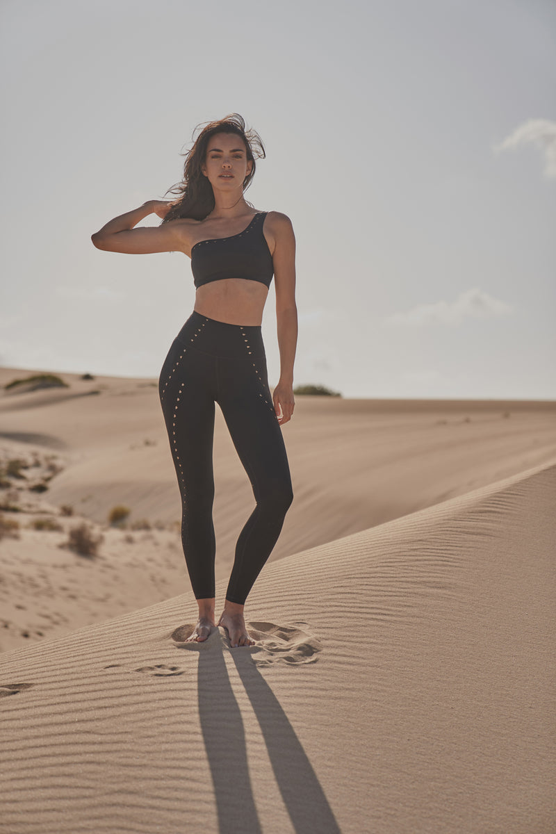 Model wears One-shoulder Laser Cut Sports Bra + Training Laser Cut Legging | WISKII