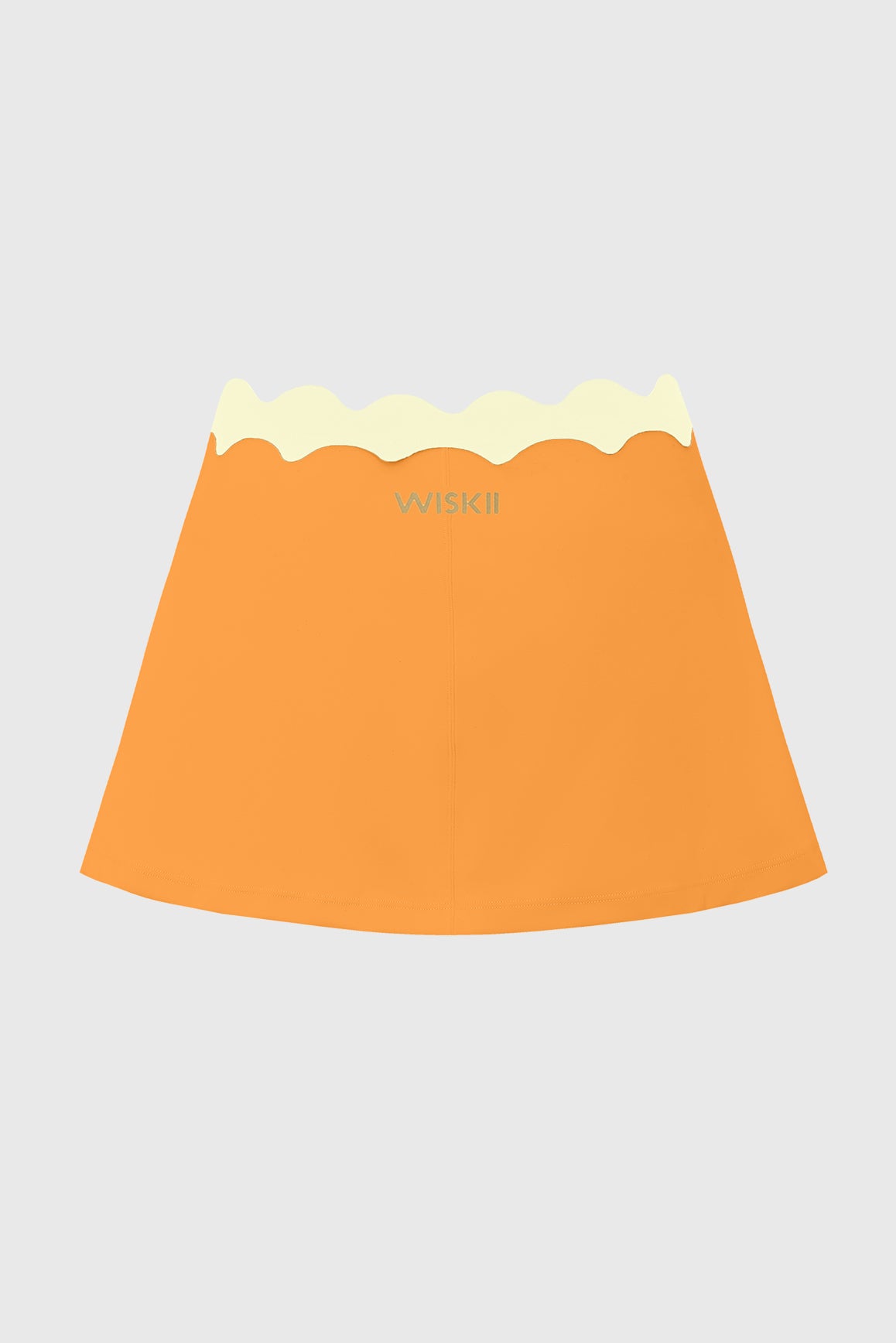 WISKII Riviera scallop contrast skirt in light fabric with scalloped hem and color-block design, laid flat.