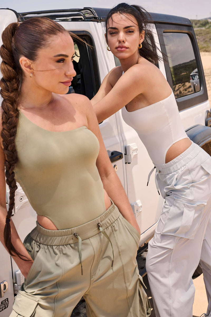 Model wears Adjustable One-Shoulder Bodysuit | WISKII Active | Muted Khaki