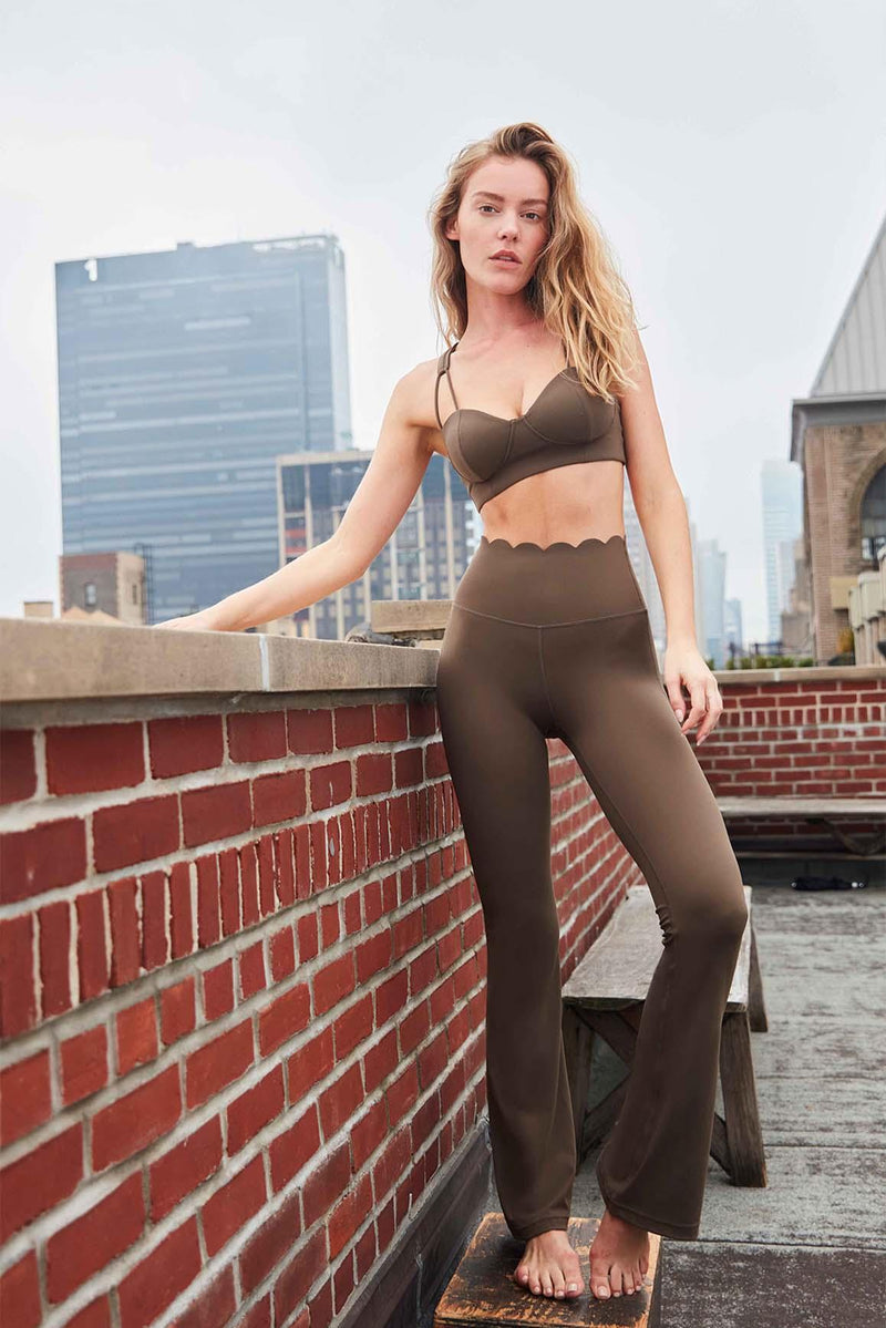 model wears Olive Green High-Waist Flare Legging with sports bra