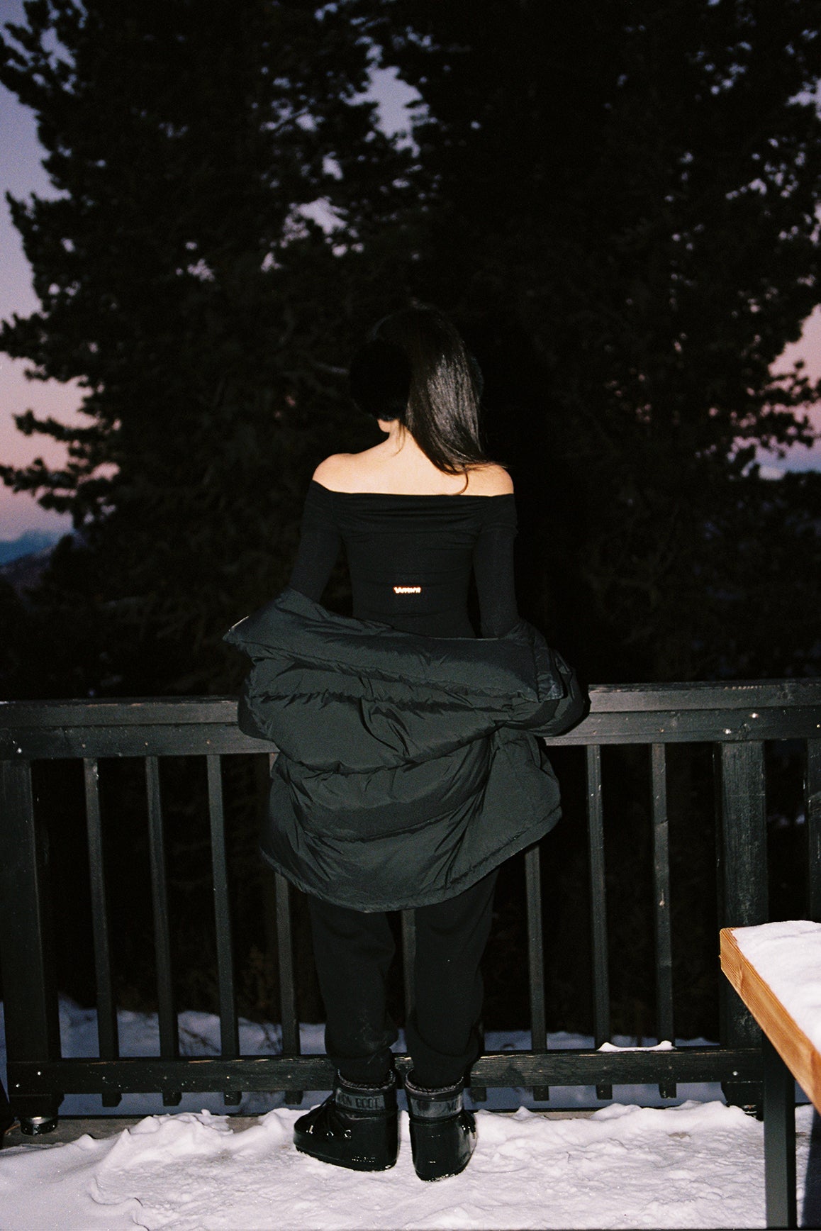 Ivory long sleeve off-shoulder pleated bodysuit by WISKII, featuring elegant pleats and a stylish silhouette.